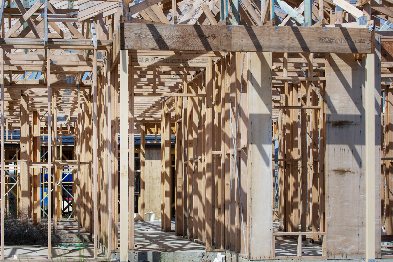 The timber frame and roof trusses of a new house under construction The timber frame and roof trusses of a new house under construction