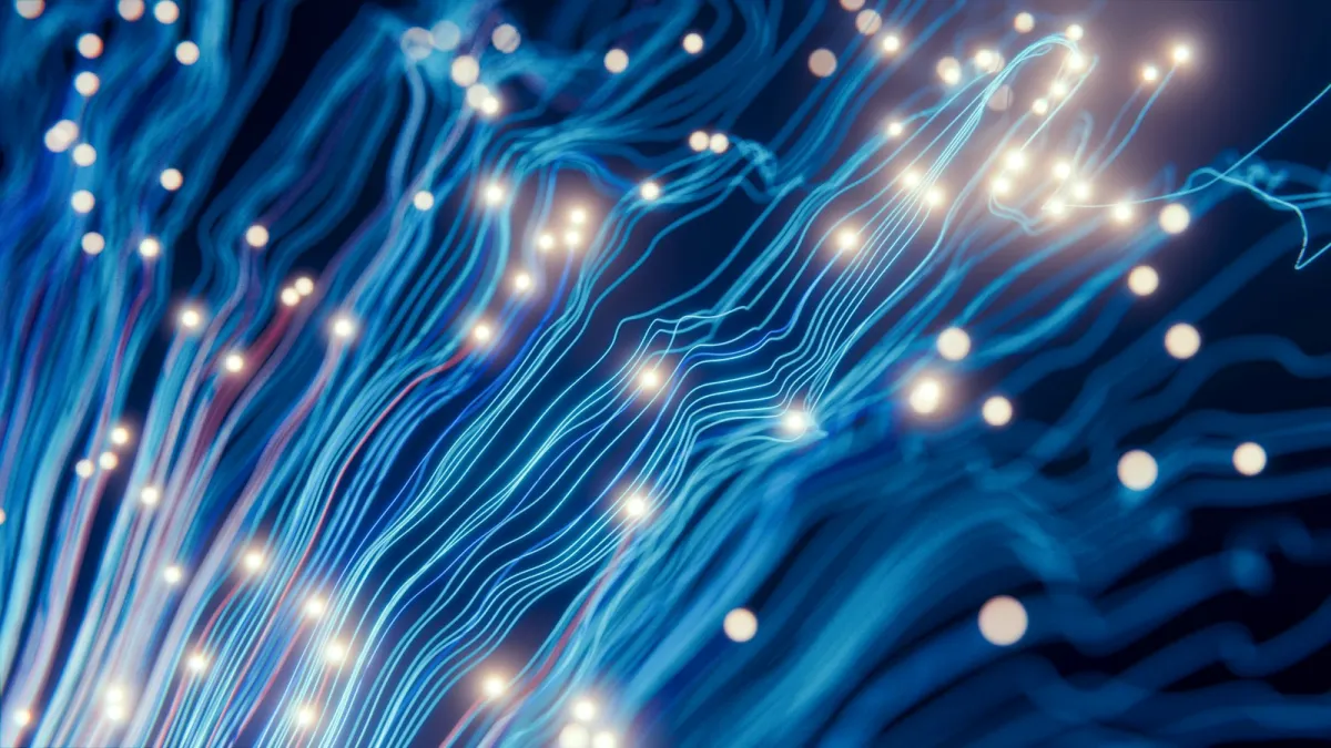 Glowing blue strands of light like fiber-optic data lines Glowing blue strands of light like fiber-optic data lines