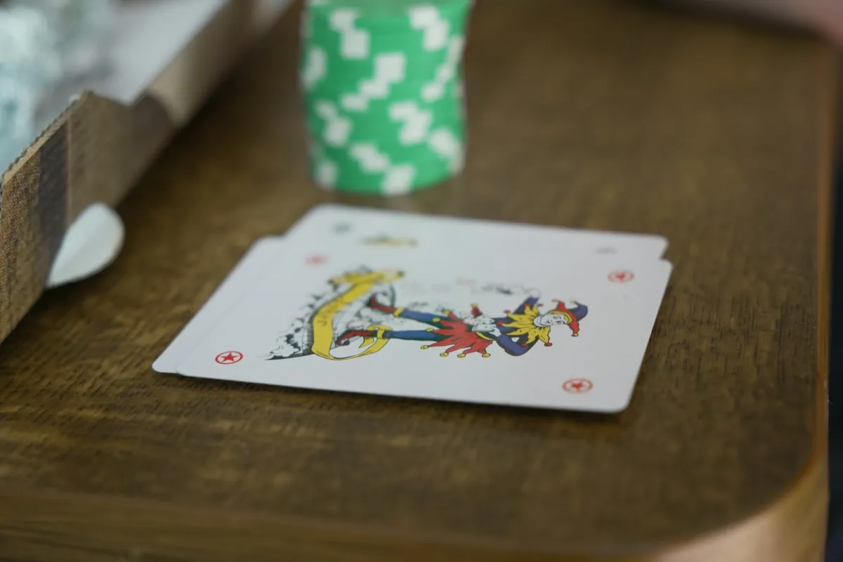 Playing cards spread on a wooden table