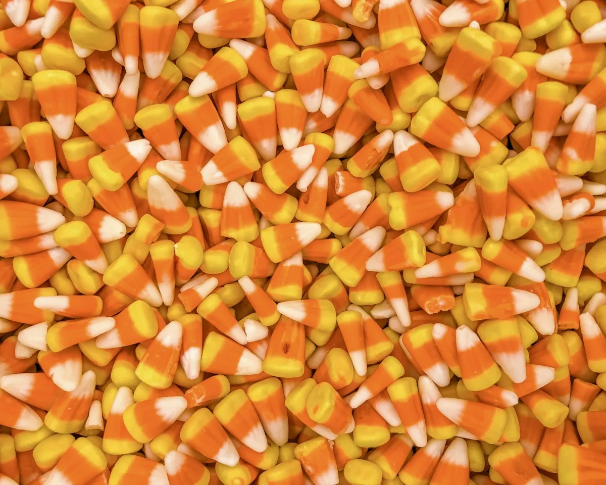 A pile of orange, yellow and white candy corn