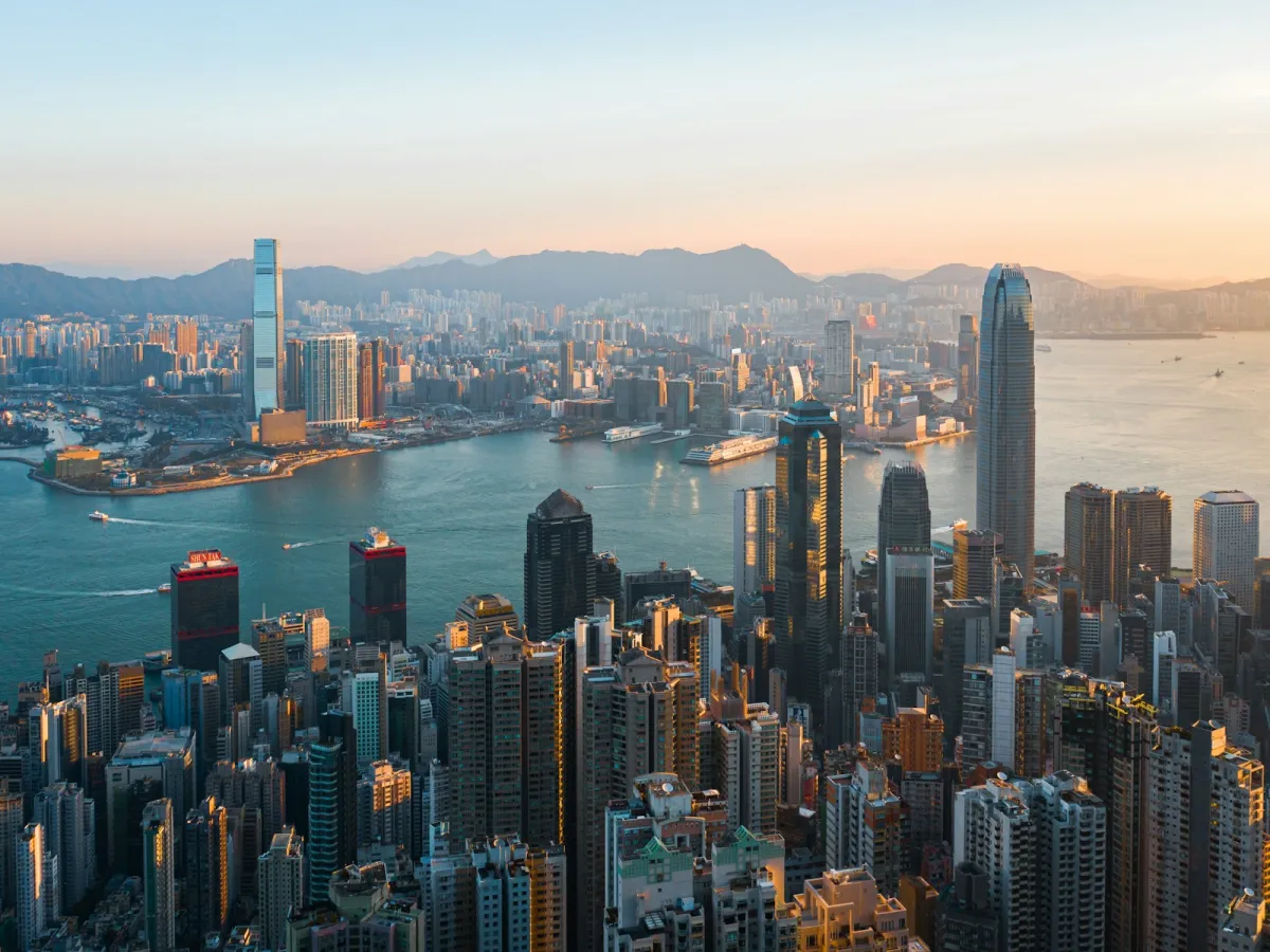 The Hong Kong skyline across Victoria Harbour at golden hour The Hong Kong skyline across Victoria Harbour at golden hour