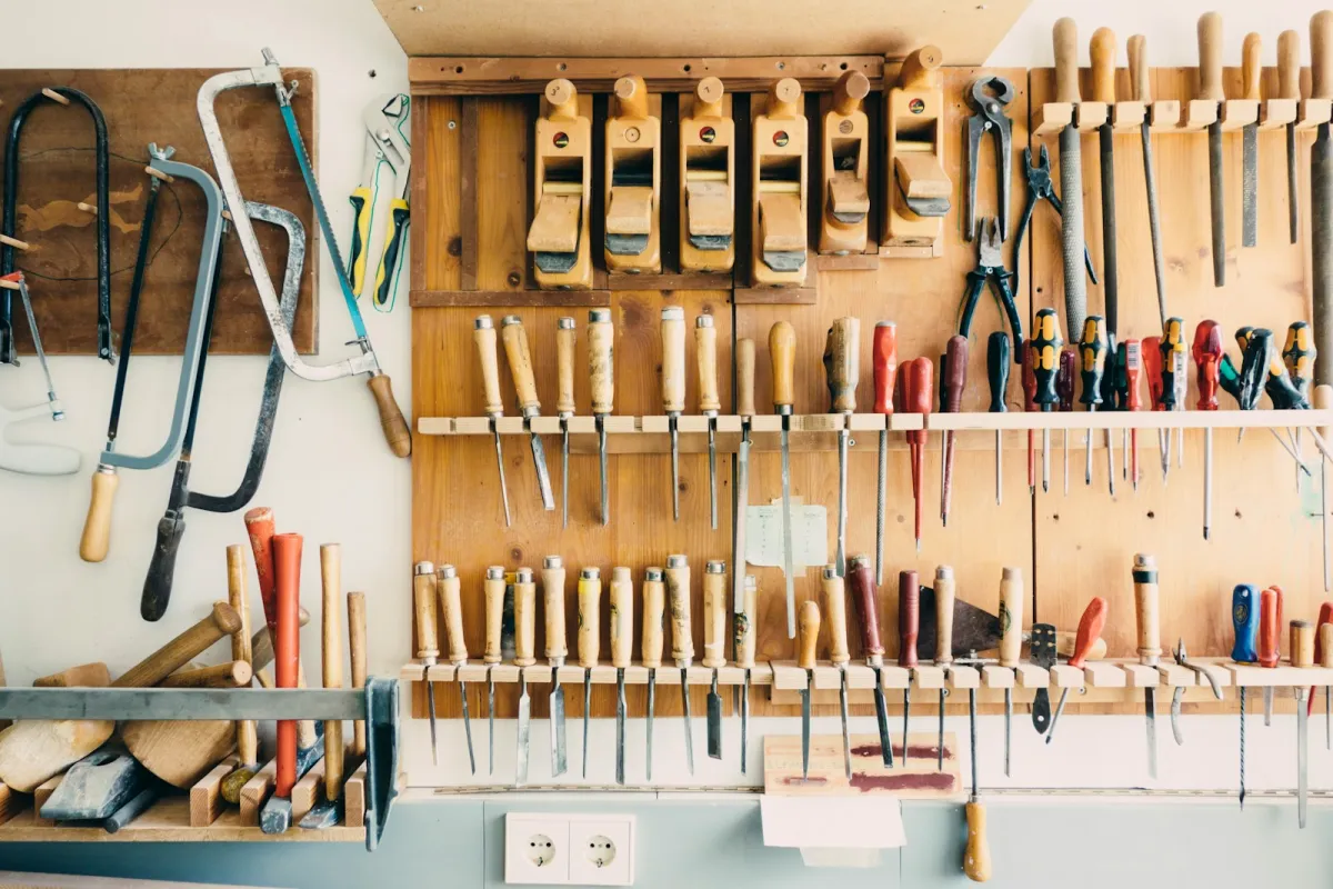 Hand tools hanging in a workshop tool rack