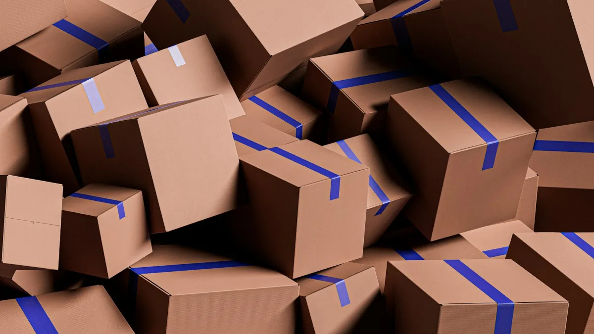 A large pile of brown cardboard boxes sealed with blue tape
