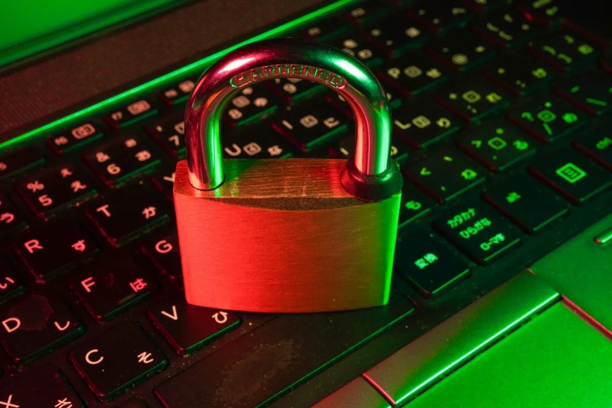 A padlock resting on a laptop keyboard lit in red and green A padlock resting on a laptop keyboard lit in red and green