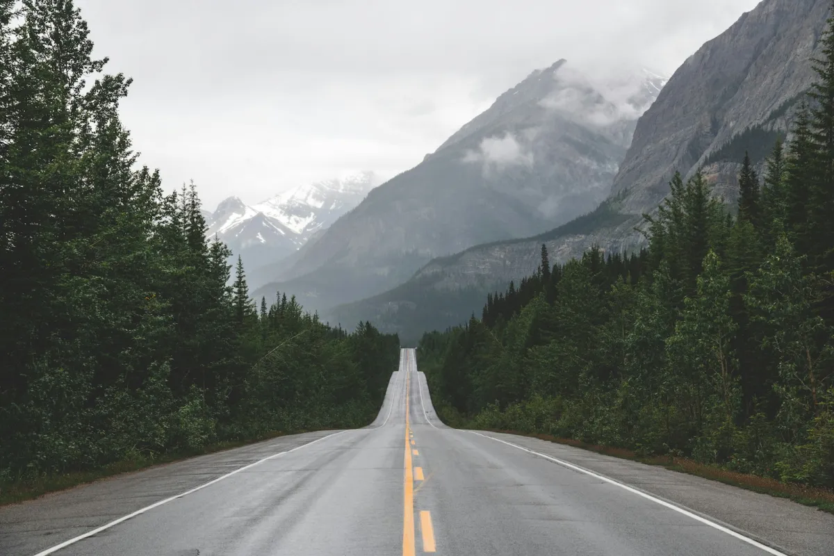 A long road leading toward a mountain