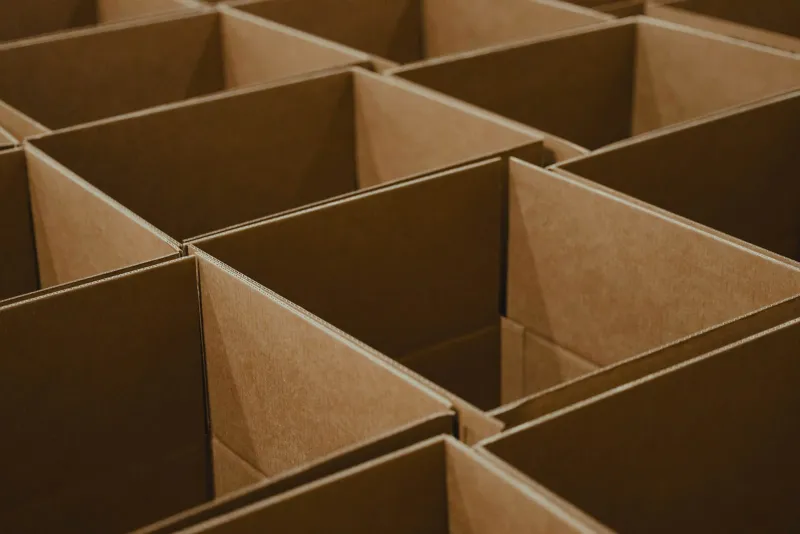 Rows of open brown cardboard boxes