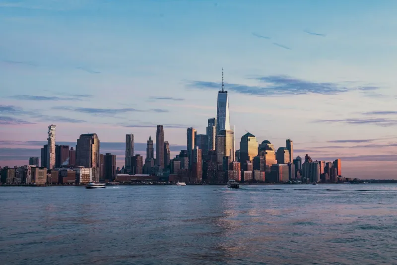 The lower Manhattan skyline across the Hudson River at golden hour